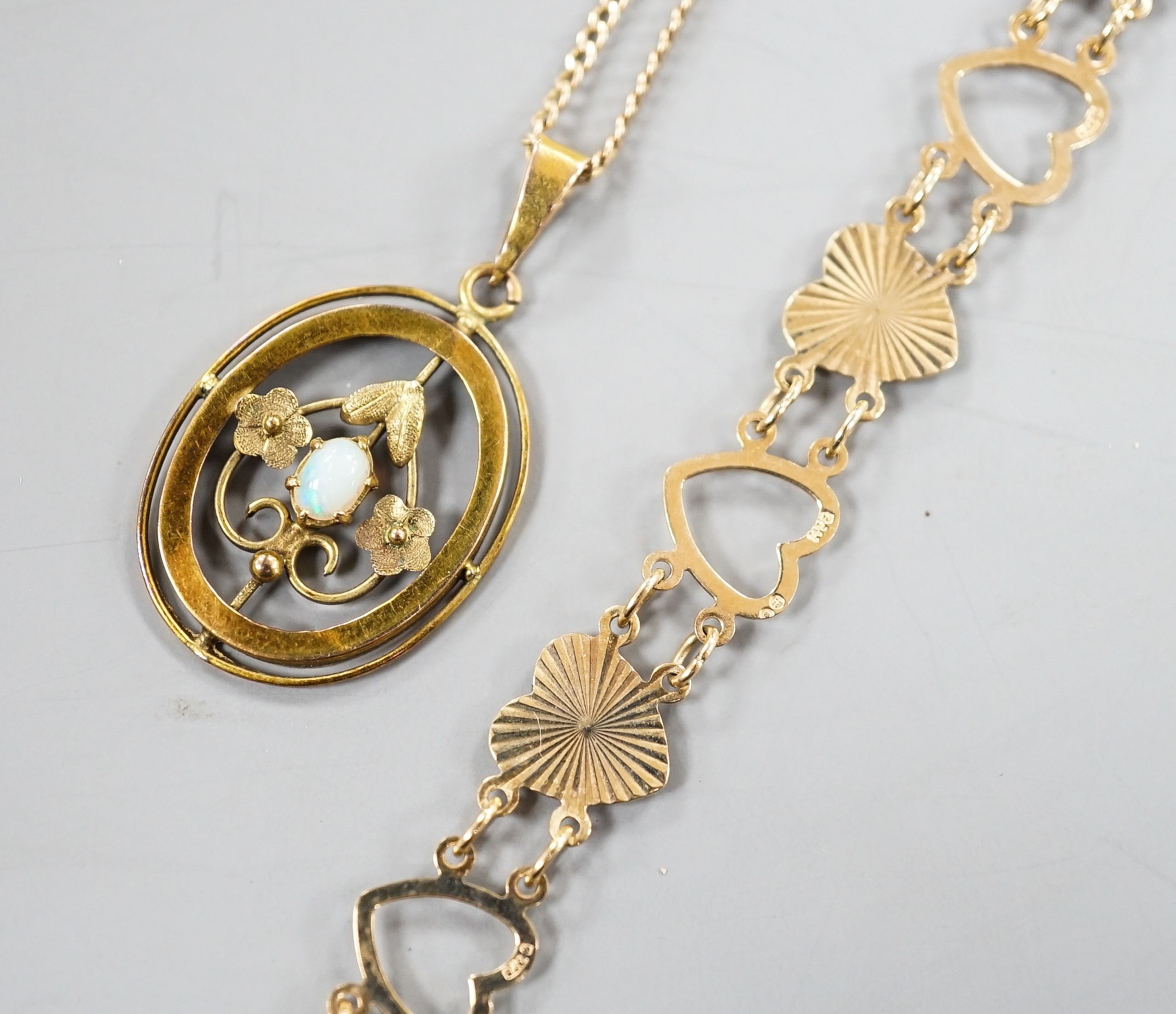 A 9ct and heart shaped link bracelet, 18cm and a yellow metal and opal pendant on a yellow metal chain